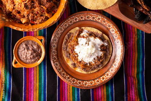 Tostada de Tinga de Res. Typical Mexican dish prepared mainly with shredded beef, onion and dried chilies. It is customary to serve it on corn tortilla tostadas. photo