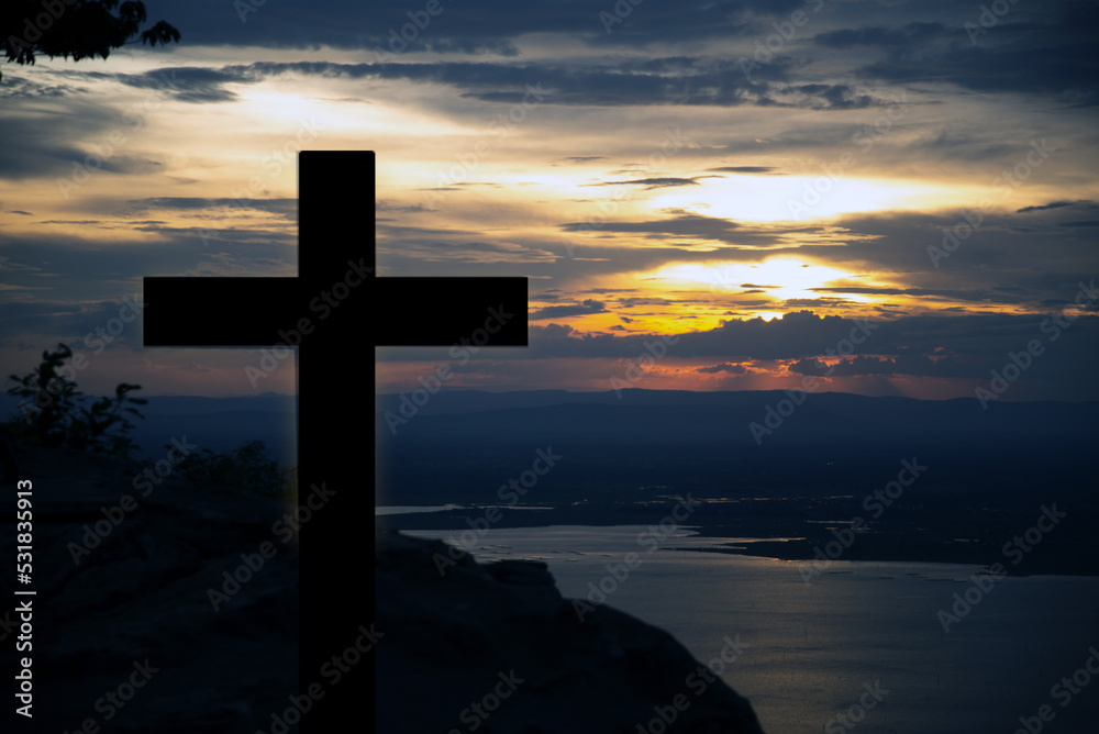 The cross of God in the rays of the sunset