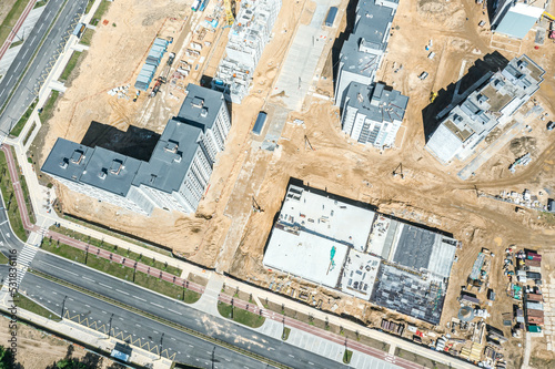 aerial view of new residential district with multilevel parking garage under construction
