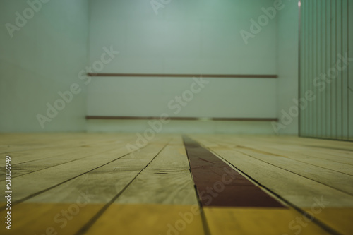 selective focus on a section of wood planking at floor level inside a racquet ball court © Lost_in_the_Midwest