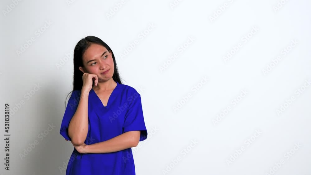 Young Female Nurse Having a Though Over Something at a White Background Young Female Nurse Having a Though Over Something at a White Background