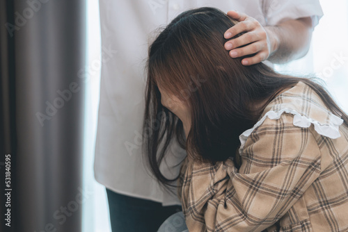 Young man comforting , supporting and holding hands a sad woman who is in serious trouble at home