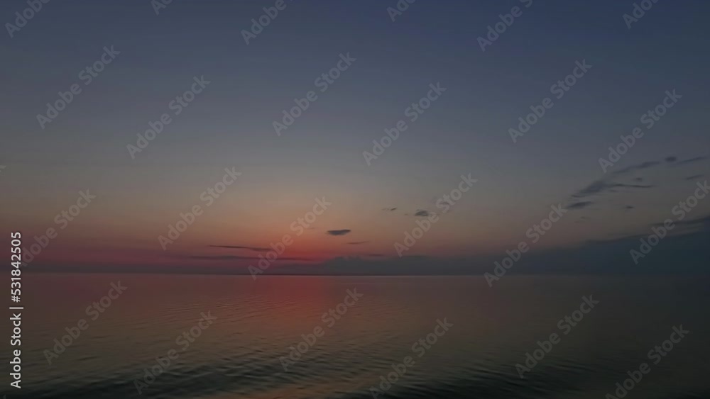 Timelapse shot of colorful sky after sunset over sea water during evening time. Timelapse shot of colorful sky after sunset over sea water during evening time.