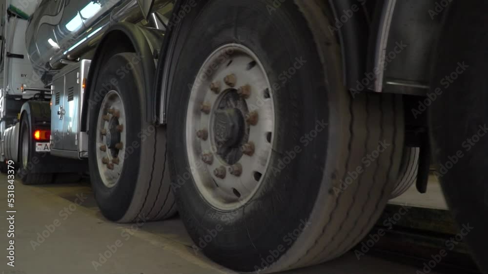truck at the service station. Annual maintenance of the semi-trailer and refrigerator. Close-up of truck wheels and tires with suspension. truck at the service station. Annual maintenance of the semi-trailer and refrigerator. Close-up of truck wheels and tires with suspension.