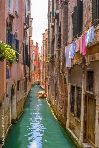 Narrow canal in Venice at summer time