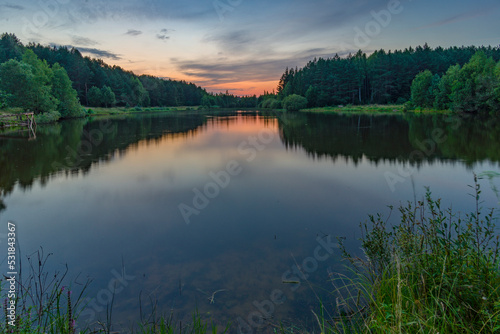 Twilight over small forest lake © Aliaksandr