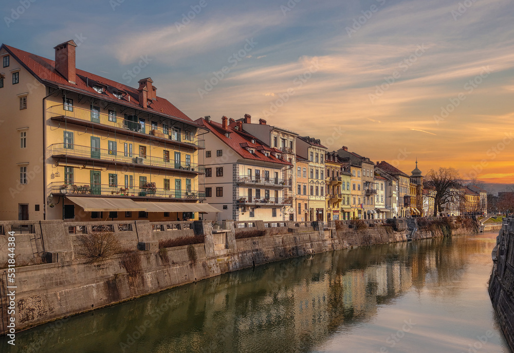 Ljubljana, Slovenia - Beautiful sunset over the old town of Ljubljana with Ljubljanica river and traditional Slovenian houses on a sunny winter afternoon