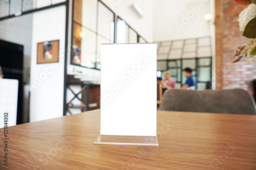 Wenu frame standing on wood table in Bar restaurant cafe. Space for text marketing promotion. 