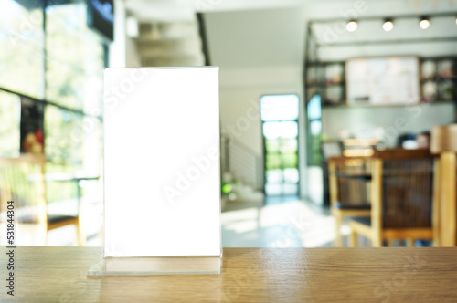 Wenu frame standing on wood table in  Bar restaurant cafe. Space for text marketing promotion. 