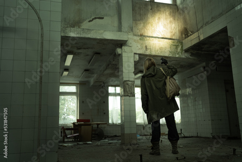 Nuclear disaster survivor in a post apocalyptic setting, woman stalker or soldier in abandoned building, environmental disaster and chemical warfare concept