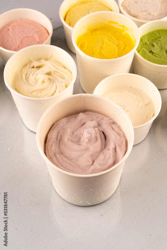 Ice creams in bright colors served in plastic tubs. Ice creams in bright colors served in plastic tubs.