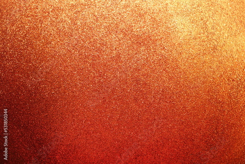 Sparkle glowing dark orange shade glitter of carborundum abstract textured background, can use for celebrate christmas day, new year day or birthday