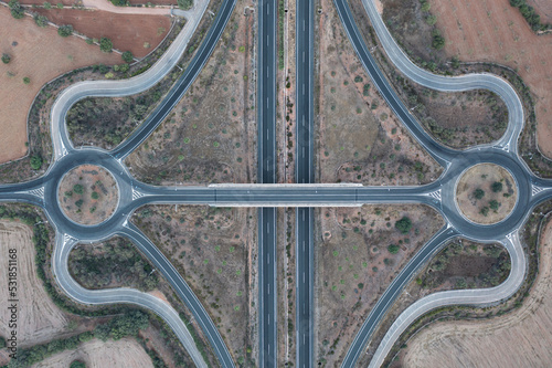 Aerial view of a bridge and highway lanes, roundabouts and conjunctions 