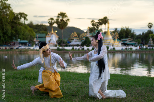 Man and woman in Burmese traditional Dancing perform the cultural costume of Tai people minority ethnic show wearing dresses Shan State style. photo