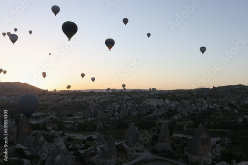 Panoramic banner landscape with hot air balloons black silhouette rising into the sky with sunrise