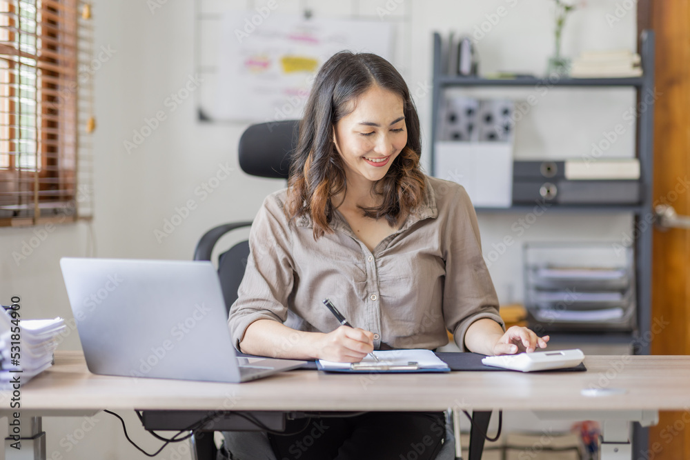 Asian businesswoman Accounting using calculating income-expenditure and analyzing real estate investment data report Financial and tax systems in workplace an home office. Asian businesswoman Accounting using calculating income-expenditure and analyzing real estate investment data report Financial and tax systems in workplace an home office.