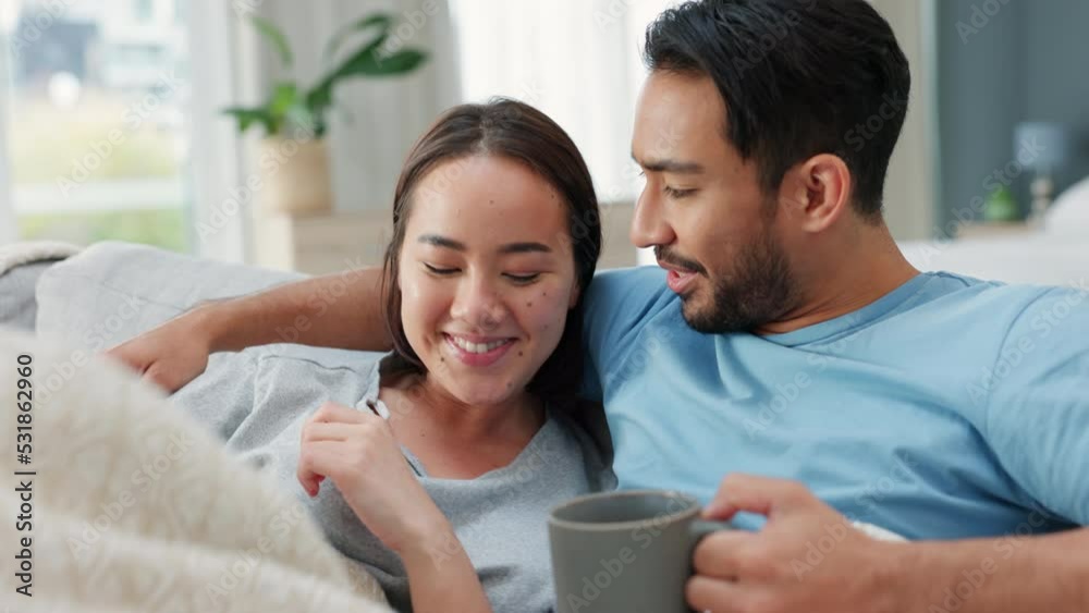 Couple, watching tv and television with coffee in living room with blanket and funny comedy movie, online streaming or video. Relax, love and cozy comfort of man and woman with film on couch or sofa. Couple, watching tv and television with coffee in living room with blanket and funny comedy movie, online streaming or video. Relax, love and cozy comfort of man and woman with film on couch or sofa.