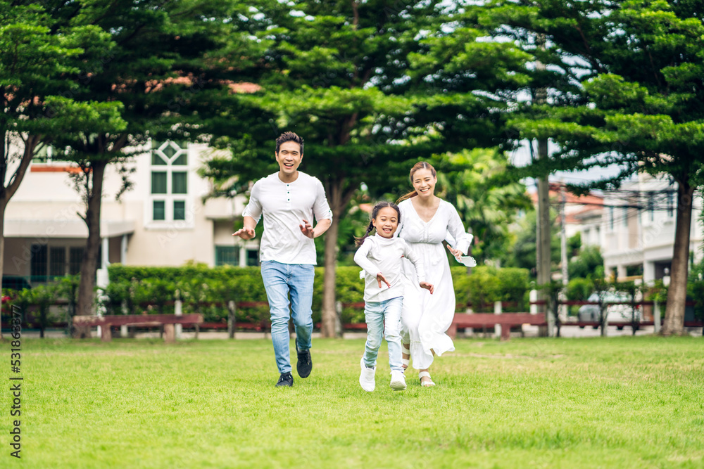 Obraz premium Portrait of enjoy happy love asian family father and mother holding hug cute little asian girl child smiling play and having fun run moments good time in summer park at home