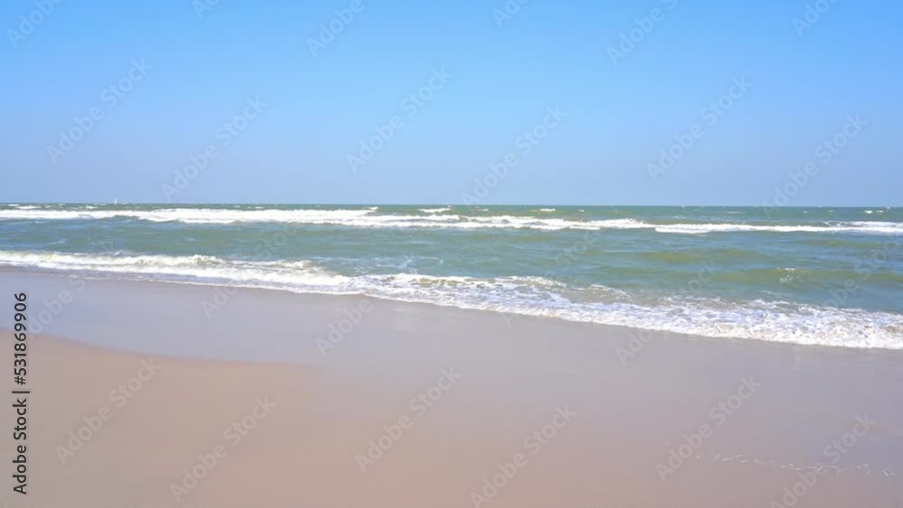Waves slowly wash up on a golden tropical beach. Waves slowly wash up on a golden tropical beach.