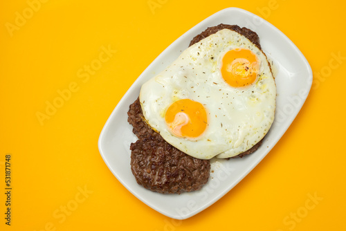 three fried ground meat with fried egg on white plate