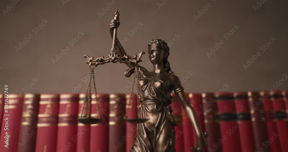 bronze blindfolded goddess representing law statue spinning, holding a