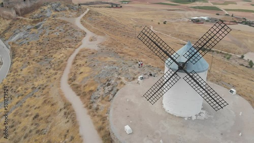 Windmills at Cerro Calderico, landscape and village below. Drone orbiting. photo