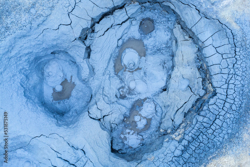 Bubbling mudpot in geothermal area photo