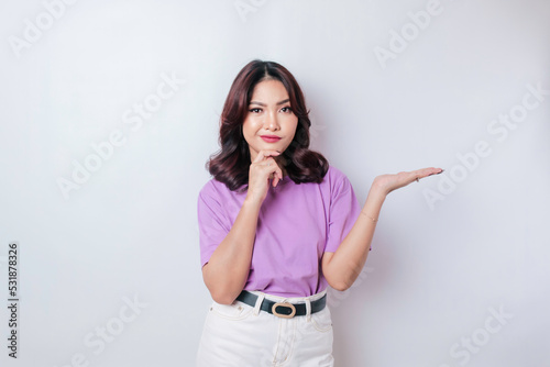 Portrait of a thoughtful young casual girl wearing a lilac purple shirt looking aside isolated over white background