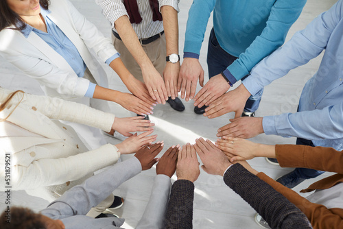 Fotografie Top view multiracial team peoples outstretched hands standing in circle symboliz
