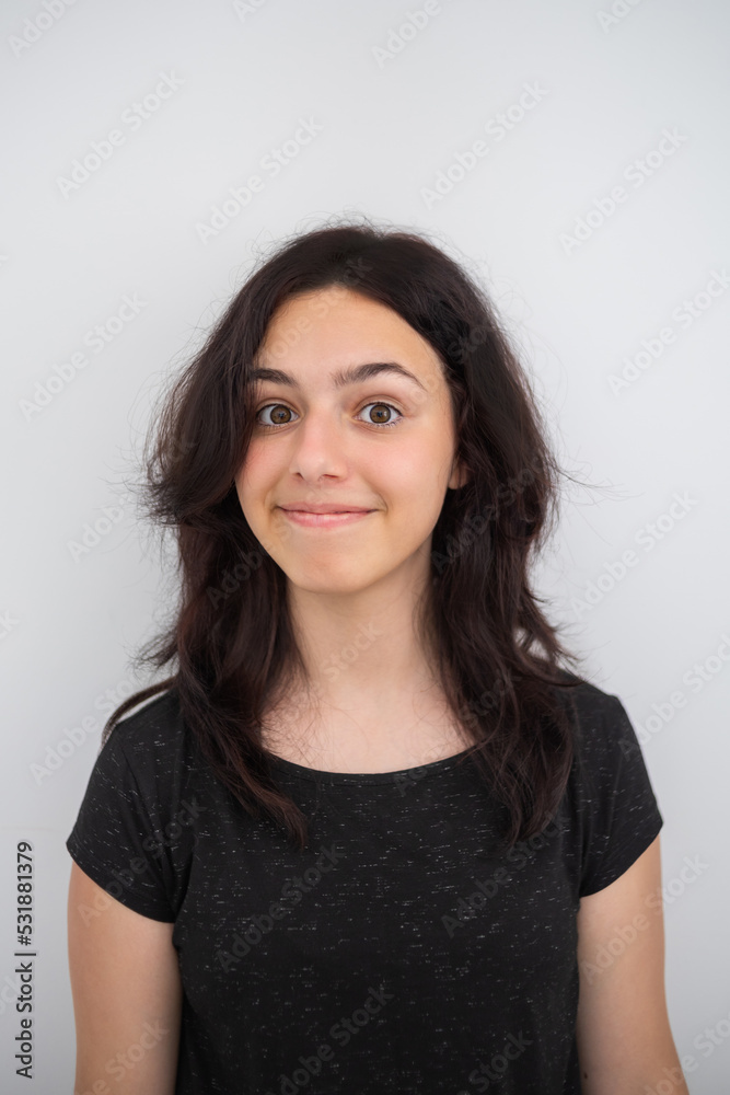 Portrait of a happy teen girl. Young girl smiling and looking at the camera Portrait of a happy teen girl. Young girl smiling and looking at the camera