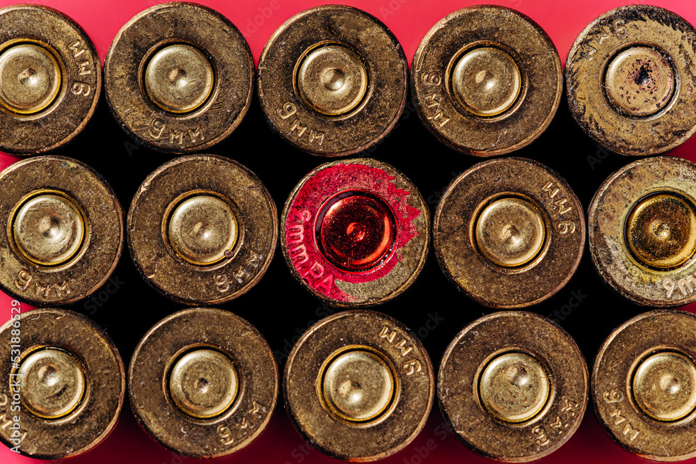 Small caliber cartridges on a red background. Small caliber cartridges on a red background.