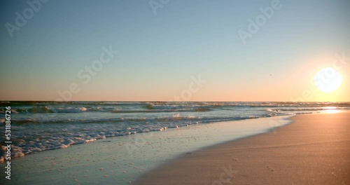 Wallpaper Mural Shots of the ocean on a warm, sunny evening with footprints in the sand  facing the sun directly Torontodigital.ca