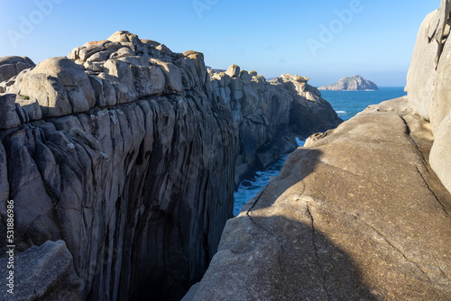 Acantilados de papel (Paper cliffs) in the Rías Altas zone in Gaiicia at sunset with sinuous rock formations. photo