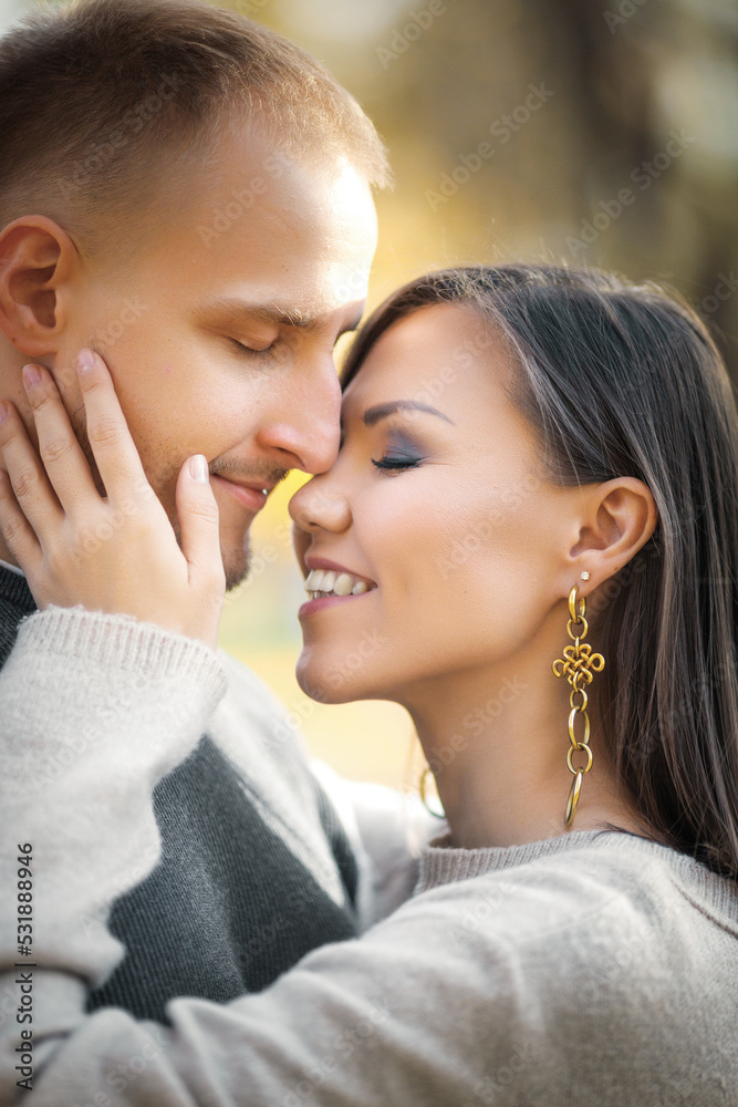 Cute romantic young couple hugging tenderly in autumn nature. Cute romantic young couple hugging tenderly in autumn nature.