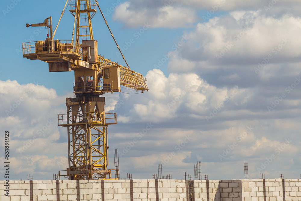 construction crane on the background of the sky and white clouds construction crane on the background of the sky and white clouds