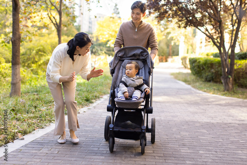 Young parents with baby in stroller