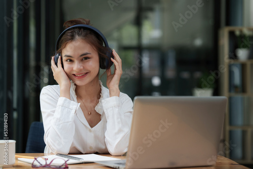 Attractive smiling young woman using mobile phone and listen music at home. lifestyle concept