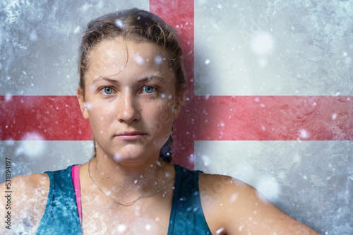 Young woman on frozen background with flag of England. Concept of crisis in UK in winter. Energy crisis. photo