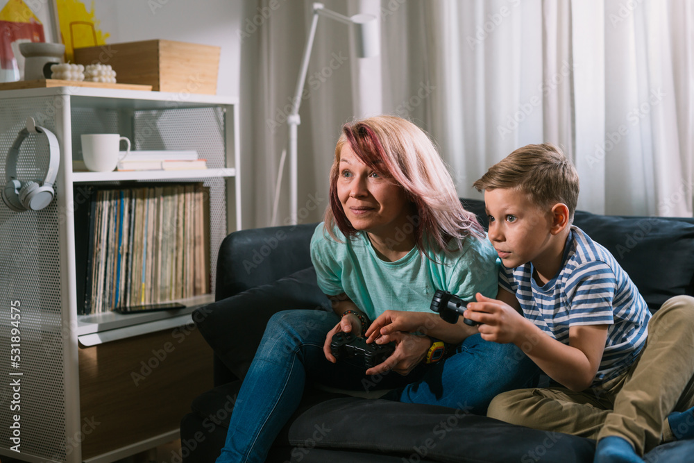 mother and son playing video games at home mother and son playing video games at home