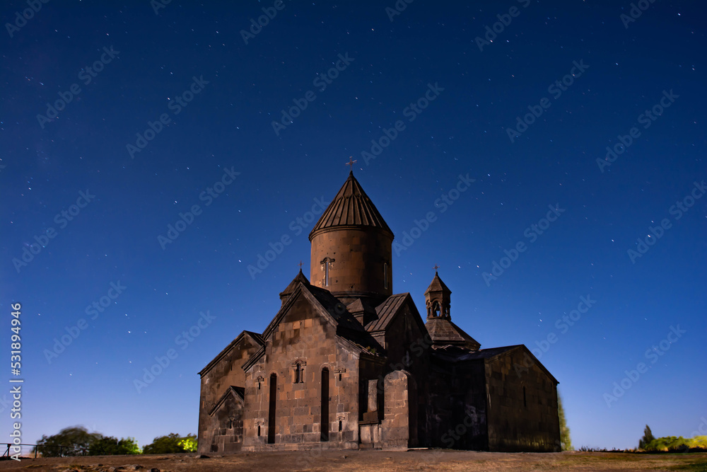 Monastery on the background of the star trails. Beautiful night sky with star trails