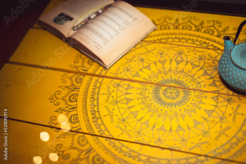 Beautiful wooden yellow table surface with mandala hand drawings