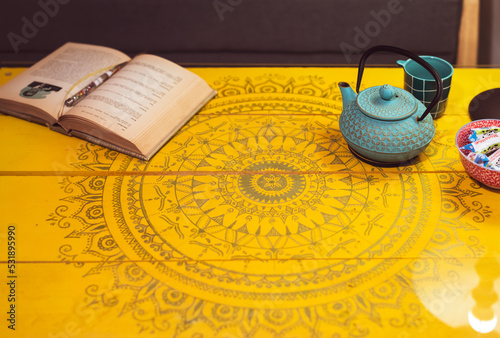 Beautiful wooden yellow table surface with mandala hand drawings