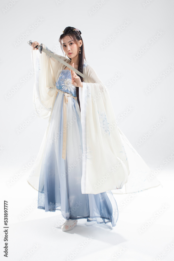 Young woman in ancient costume holding a sword Young woman in ancient costume holding a sword