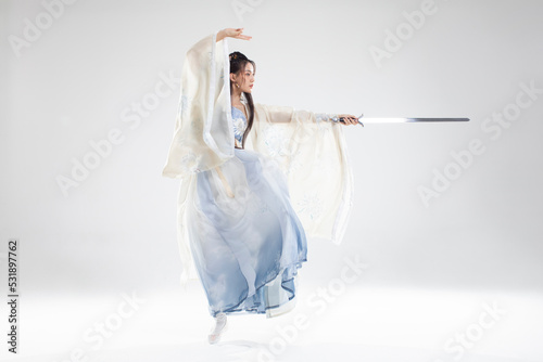 Young woman in ancient costume holding a sword
