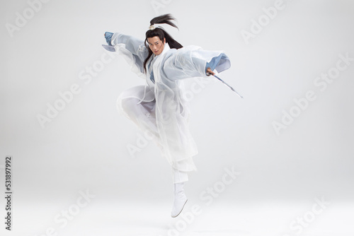 Young swordsman in ancient costume