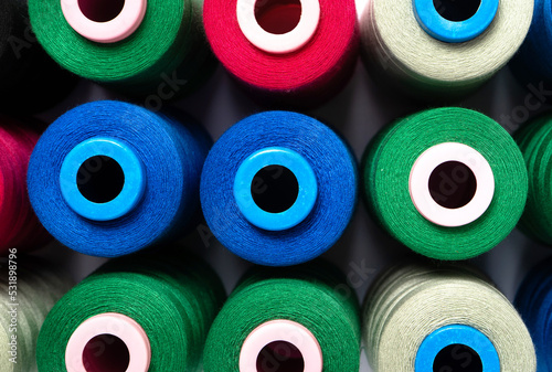 Sewing threads as a multicolored background close up. Pattern of pink, blue, green and pistachio threads