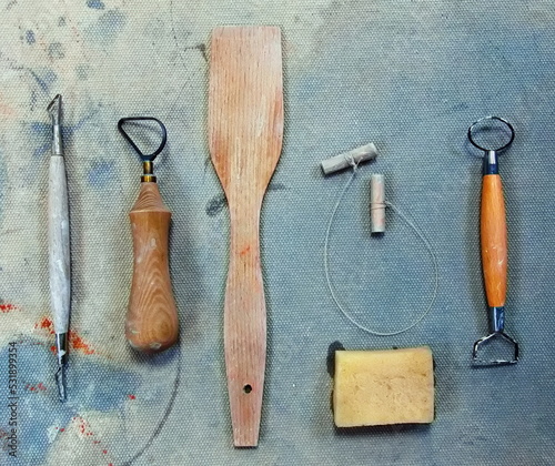 Pottery tools like loops and knives on Dirty Grunge  Background in a pottery workshop. photo