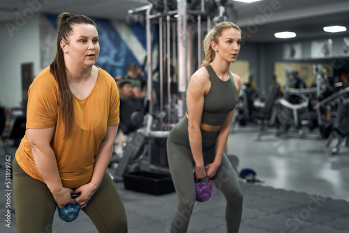 Two caucasian women training at the gym
