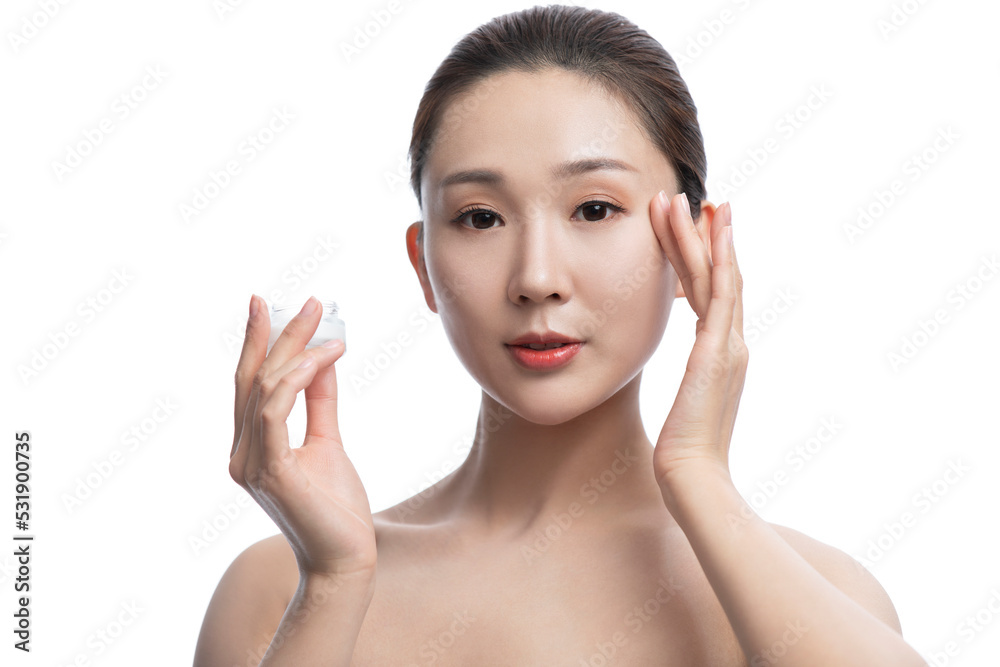 Beautiful young woman applying moisturizer Beautiful young woman applying moisturizer