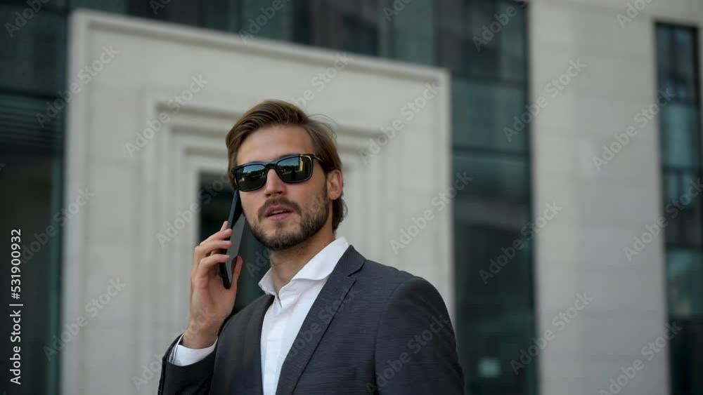 Handsome Startup Businessman using mobile Phone. Young man texting Messages, talking on his Smartphone while walking Handsome Startup Businessman using mobile Phone. Young man texting Messages, talking on his Smartphone while walking